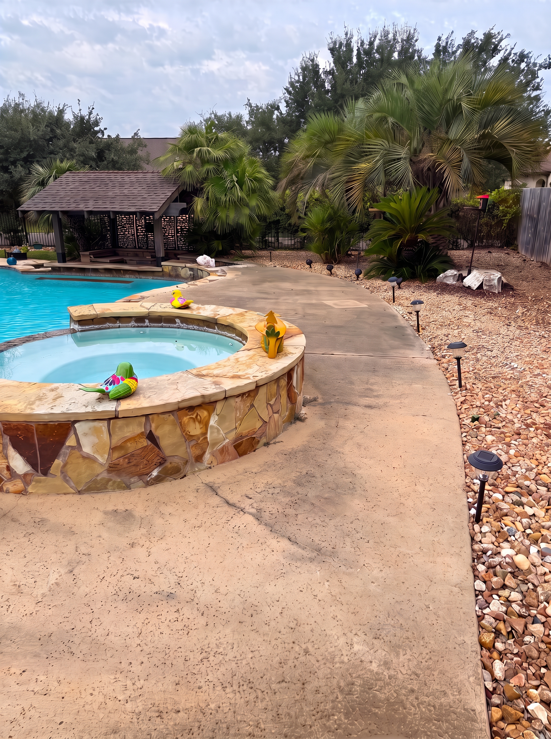 Pool deck concrete dark with dirt and algae before pressure washing
