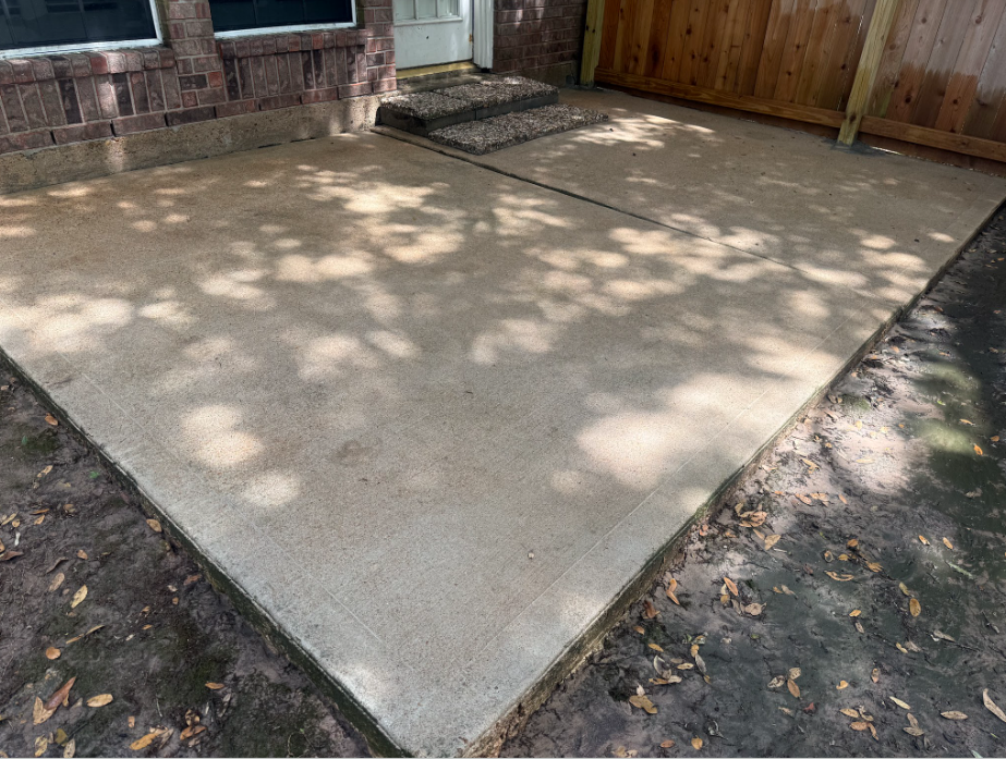 Same concrete patio cleaned to a uniform light finish after pressure washing